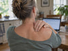 Woman pressing the knot on her shoulder blade