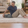 Man pressing the power button and lying back on Dorsawell One